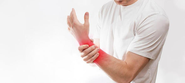 Man holding his wrist and forearm pain areas.